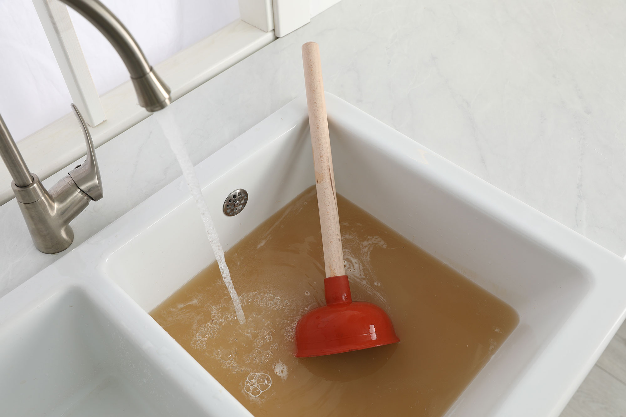 clogged kitchen sink with plunger